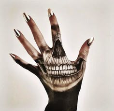 a person's hand with skeleton painted on it