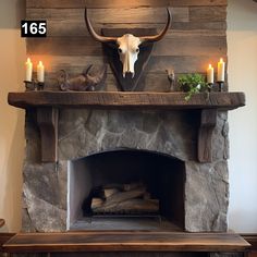 the fireplace is decorated with candles and an animal's head mounted on the mantle