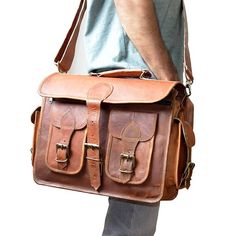 a man carrying a brown leather briefcase on his back with one hand and the other shoulder