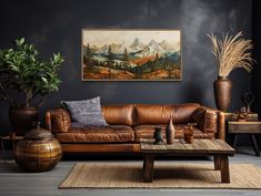 a living room filled with furniture and a painting on the wall above it's coffee table