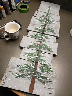 some wood planks are decorated with pine trees