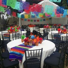 tables and chairs are set up with colorful decorations