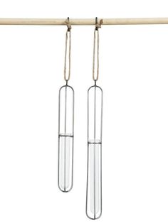 two long metal tubes hanging from a wooden bar with rope attached to them, on a white background