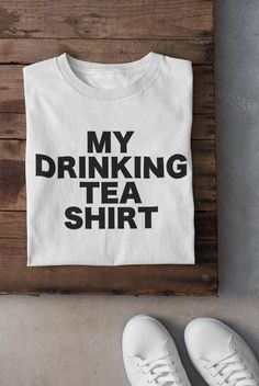 Do you love tea? Then this "My Drinking Tea Shirt" is the perfect addition to your wardrobe! Whether you're a dedicated tea enthusiast, a cozy tea drinker, or just love a good pun, this quirky shirt is designed just for you. Made from soft, high-quality cotton, this t-shirt is not only comfortable but also the ideal way to express your love for tea in a fun and stylish way. Perfect as a gift for tea lovers, this shirt makes a great present for birthdays, holidays, or just because. Featuring a cu Tea Puns, Tea Enthusiast, Cozy Tea, Pun Shirts, Best Puns, Tea Shirt, Gift Tea, Gift Of Time, Tea Lovers