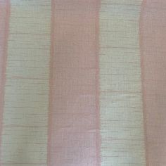 a pink and white striped fabric with small stripes on it's side, as well as an orange stripe in the center