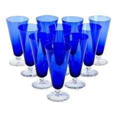 six blue glasses are lined up in a row