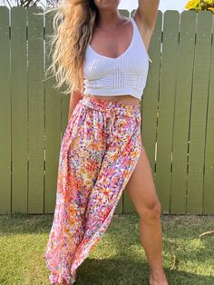 Ditch those boring trousers and upgrade to our Tulip Gardens beach pants! Featuring a flared leg and unique split tulip hem, these printed pants will have you turning heads. Made with 100% rayon for a comfortable and stylish fit. Get ready to stand out in these fun and playful pants! Summer Vacation Boho Print Bottoms, Summer Beach Boho Print Bottoms, Summer Floral Print Wide Leg Pants, Casual Boho Print Bottoms For Beach, Summer Wide Leg Floral Print Pants, Summer Floral Print Wide-leg Pants, Summer Wide Leg Pants With Floral Print, Floral Print Wide Leg Pants For Day Out, Bohemian Floral Print Bottoms For Vacation