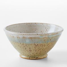 a brown and white bowl sitting on top of a table