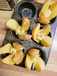 several muffins in a muffin tin on a wooden table