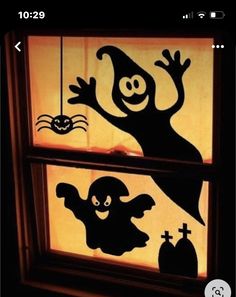 a window decorated with halloween decorations in the dark