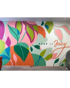 a colorful wall mural in an office with the words, keep it juicy on it