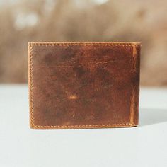 The Classic Mens Bifold Leather Wallet Made from quality, genuine leather, this men's bifold leather wallet is made to go the distance. With 9 separate cardholder slots, you can fit all your debit, credit and membership cards in this men's brown leather wallet. With an additional clear pocket for your ID, this bifold wallet is also built to make it convenient to flash your driver's license. Need even more space? The two inside left and right pockets can take even more of your cards or any loose change. Keep your bills stored in either one of the two full-width pockets on the top of this bifold leather wallet. Say hello to your new premium everyday pocket buddy, The Bifold. Features A genuine top grain leather wallet Bifold wallet design Nine card slots in the inside of the wallet Two addit Mens Leather Wallet Bifold, Wallet Design, Minimalist Leather Wallet, Fun Wallets, Real Leather Bags, Id Design, Loose Change, Brown Leather Wallet, Leather Company