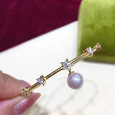 Highlight: Adjustable Bangle Product Information OriginJapan MaterialAkoya Pearl, 18k Gold, and Diamond Dimensions- Pearl Shaped: Round Size: 8-8.5 mm Quality: AAA Nacre: Very Thick Color: Rose Overtone Luster: Very High Accessories Metal: 3.8g of 18k Gold Other: 0.22ct of SI Quality Natural Diamond Akoya Pearl Ring, Pearl Chandelier Earrings, Akoya Pearl Earrings, Pearl Chandelier, Golden South Sea Pearls, Adjustable Bangle, South Sea Pearls, Sea Pearls, Akoya Pearls