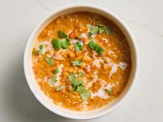 a white bowl filled with soup and garnished with cilantro