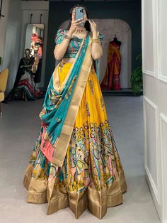 Introducing our stunning "impressive yellow kalamkari printed dola silk traditional lehenga choli," designed to make you stand out on any festive occasion. This gorgeous ensemble features a yellow color dola silk material lehenga with intricate kalamkari print work and zari weaving border work, paired with a blue color dola silk choli embellished with matching details. The look is completed with a blue color dola silk dupatta that also boasts kalamkari print work and zari weaving border work, al Lehenga Yellow, Silk Half Saree, Kalamkari Prints, Lehenga Sari, Sari Lehenga, Kalamkari Print, Lehenga Choli Designs, Lehenga Crop Top, Printed Lehenga