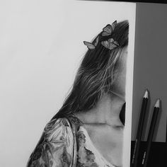 a pencil drawing of a woman with butterflies on her head