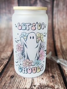 a glass jar with a white ghost on it and the words let's go grow