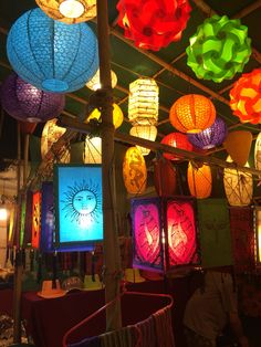 many colorful lanterns are hanging from the ceiling