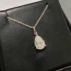 Moissanite offers timeless beauty and exceptional value. This beautiful pendant and chain set features a GRA certified VVS1 clarity D color Moissanite hand set by our master jewelers on a durable 14K gold setting. This is the best compromise between cheap fakes (CZ, crystal, rhinestone) and an extremely expensive diamond. Natural diamond equivalent stones cost $10,000 - $100,000+. Get the same look at a reasonable price. Necklace can be worn at 16, 17, and 18 inch lengths. Order yours today! -Be Luxury Pear-shaped Necklace With Halo Setting, Timeless Pear-shaped Diamond White Jewelry, Pear-shaped Lab Grown Diamond Jewelry As Gift, Lab Grown Diamond Pear-shaped Jewelry Gift, Pear-shaped Lab Grown Diamond Jewelry For Gift, Pear-shaped Lab Grown Diamond Jewelry Gift, Gift Jewelry With Pear-shaped Lab Grown Diamond, Diamond White Pear-shaped Solitaire Necklace, Fine Jewelry Pear-shaped Solitaire Necklace In Cubic Zirconia