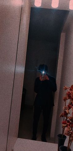 a man taking a selfie in front of a mirror with his cell phone up to his face