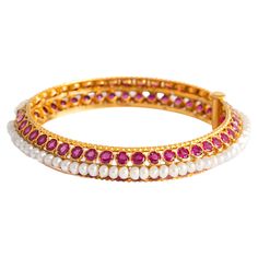 Indian Bangle set by baroque pearls and round cut rubies on yellow gold. Circumference: approximately 19.00 centimeters. Weight: 39.00 grams. Ruby And Diamond Bangles, Luxury Ruby Bangle Jewelry, Yellow Gold Ruby Bangle Bracelets, Ruby Bangle Bracelet With Intricate Design, Intricate Ruby Bangle Jewelry, Ruby And Pearl, Diamond Bangles, Bangles Indian, Gold Bangle