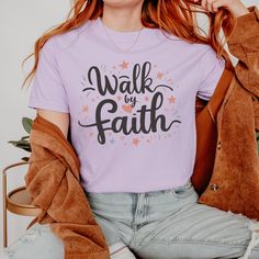 Step out in faith with our 'Walk by Faith' Christian t-shirt. This simple yet powerful message serves as a reminder to trust in God's guidance every step of the way. Crafted with comfort in mind, it's perfect for daily wear. Let it inspire you and others to embrace the journey of faith with courage and conviction. Features: Vintage Feel: Comfort Colors nails the aged charm, turning new shirts into instant classics with their iconic, well-loved vibe. Fabric Quality: Crafted from 100% ring-spun US Inspirational Crew Neck T-shirt With Lettering, Inspirational Lettering Crew Neck T-shirt, Inspirational Slogan Shirt, Cotton T-shirt With Faith Text Print, Gifts Christian, Clothing Guide, Jesus Shirt, Christian Apparel, Christian Shirt