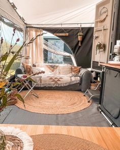 the inside of a camper with furniture and decor