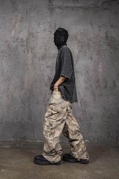 The Multi-Pocket Desert Cargo pants seamlessly blend street style with military aesthetics. Featuring an all-over camo print, these pants have a unique scimitar-like shape that creates natural creases, enhancing their edgy look. The multiple pocket design adds both functionality and a rugged appeal. Made from premium 100% cotton fabric, these pants ensure comfort and durability. The slightly oversized fit provides a relaxed, contemporary silhouette, making them an ideal choice for those who appr Camo Cargo Pants Outfit, Whale Fall, Streetwear Inspiration, Fall Graphic, Desert Camo, Camo Cargo Pants, Utility Pants, Edgy Look, Kids Branding