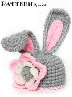 a crocheted bunny with a flower on it's head is shown in front of a white background