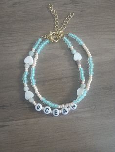 These bracelets are homemade with tiny creamy white beads and tiny light blue glass beads and small white hearts with beads spelling the word "ocean" on it. Measures from 7.5 - 9.5 inches long when opened. the package comes with two in a pack. made with invisible string and a golden clasp with golden chain for resizing. aesthetic to wear to a beach or take cute pics on a board walk. Cheap Adjustable Beaded Bracelets Beachy Style, Cheap Beaded Bracelets With Lobster Clasp For Beach, Cheap Adjustable Beaded Bracelets For Beach Party, Cheap Beaded Jewelry For The Beach, Cheap Beaded Chain Bracelet For Beach, Cheap Colorful Beaded Bracelets For Beach Season, Blue Heart Beads Friendship Bracelets For Beach, Personalized Blue Beaded Bracelets For Beach, Personalized Blue Bohemian Beaded Bracelets