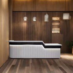 a white and black bench sitting on top of a hard wood floor next to a wooden wall