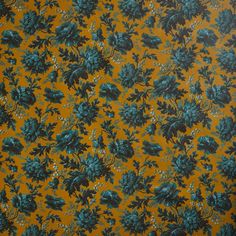 an orange background with blue flowers and leaves on it's surface, which is very similar to the wallpaper