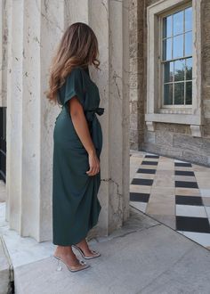 PRODUCT DETAILS: Satin midi dress in dark green Short sleeve Waist tie Functional buttons True to size Minimal stretch Length: 55" 95% Polyester, 5% Spandex Model 1 is wearing a Small Model 1 Info: Height: 5'3", Bust: 36 3/4". Waist: 30", Hips: 38.5" Model 2 is wearing a size Medium Model 2 Info: Height: 5'6", Bust: 41", Waist: 34, Hips: 41" Green Short Sleeve Maxi Dress For Work, Elegant Green Wrap Dress With Tie Waist, Green Maxi Dress With Short Sleeves For Date Night, Green Short Sleeve Maxi Dress For Date Night, Green Maxi Dress With Tie Waist For Party, Chic Green Wrap Dress For Work, Green Short Sleeve Midi Dress For Work, Green Midi Length Wrap Dress For Work, Elegant Green Wrap Dress For Date Night