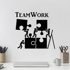 a wall sticker with the words teamwork and puzzle pieces in black on a white background