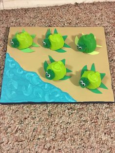 some green plastic fish on a blue and yellow mat