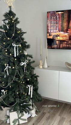 a decorated christmas tree in the corner of a room