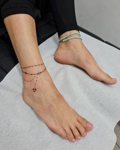 a woman's foot with a tattoo on it