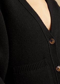 Description Accented by fisherman’s rib-stitched trim, patch pockets, and tortoiseshell buttons, this deep v-neck cardigan envelops the body in mid-weight cashmere selected for its exceptional softness and robust texture. The cropped silhouette is balanced by relaxed, extended sleeves. Details Material: Cashmere (95% cashmere 5% elastane)Care: Dry cleanFit: Runs true to size. Model is 5'9", wearing size S. Classic Black Cashmere Cardigan, Wool V-neck Cardigan For Work, V-neck Cashmere Outerwear With Buttons, V-neck Wool Sweater With Buttons, V-neck Wool Cardigan With Buttons, Classic Black V-neck Cardigan, V-neck Cashmere Cardigan With Pockets, Wool V-neck Cardigan With Pockets, V-neck Wool Cardigan With Pockets