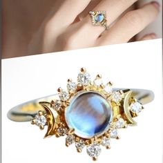 a woman's hand wearing a ring with an oval blue stone surrounded by diamonds