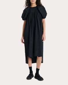 A celebration of Cecilie Bahnsen's hyper-feminine aesthetic, the Penelope dress falls in softly pleated form from its gathered babydoll bodice to its midi-length hem. Pintucked folds along the puffed sleeves and voluminous skirt bring soft dimension to the cotton silhouette.Back tie closureGathered babydoll bodicePuffed raglan sleevesPintucked details100% cottonMachine wash, dry flatMade in Portugal Size & Fit Garment measurements (size UK 8 / US 4): 53.35in long from center front neckline to he Pleated Midi Dress With Voluminous Skirt, Billowy Pleated Dress For Daywear, Midi Dress With Gathered Neckline For Gatherings, Voluminous Ruched Dresses For Daywear, Billowy Midi Dress With Gathered Neckline For Daywear, Knee-length Ruched Dress With Voluminous Skirt, Billowy Pleated Midi Dress, Billowy Knee-length Midi Dress For Daywear, Voluminous Midi Dress With Ruffles