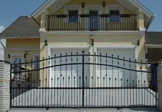 a large house with a gate in front of it