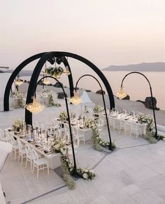 an outdoor wedding setup with white flowers and candles