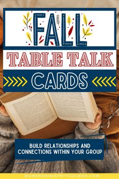 a person holding an open book with the words fall table talk cards in front of them