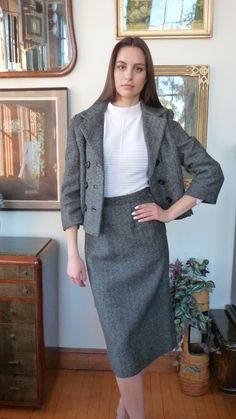 Beautiful custom made 1950s/early 1960s vintage suit.  Black and white herringbone wool. Double breasted six buttons. Hand bound button holes. Notched collar. Three quarter sleeves with seams at elbow length. Boxy cropped jacket with two vents in front. French seams front and back. Slim narrow skirt. 1" waistband with snap and hook and eye closures. Side seam zipper. Kick pleat. Unlined. Made to order - no labels. Measurements Jacket Bust up to 35" Length 21" Shoulder16 1/2" Sleeve 20" Vents Measurements Skirt Waist 27" Hip 36-37" Length 28" Hem 3" Kick pleat 8 1/2" Condition: Excellent. The suit has been dry-cleaned and is ready to wear. Buy with confidence. We accept returns. Retro Tweed Jacket With Buttons For Work, Retro Tweed Jacket For Work With Buttons, Classic Winter Semi-formal Skirt Suit, Classic Winter Skirt Suit For Semi-formal Occasions, Classic Long Sleeve Tweed Skirt Suit, Classic Tweed Skirt Suit With Long Sleeve Jacket, Classic Skirt Suit With Buttons For Career, Formal Tweed Fitted Skirt Suit, Classic Winter Skirt Suit With Button Closure