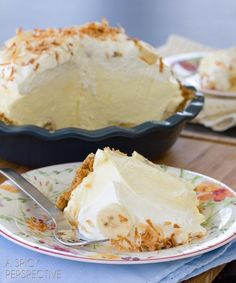 a piece of pie sitting on top of a plate next to a bowl and fork