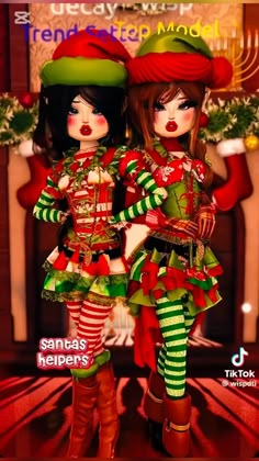 two dolls are dressed up in christmas outfits and hats, standing next to each other