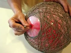 a person is working on something that looks like a ball