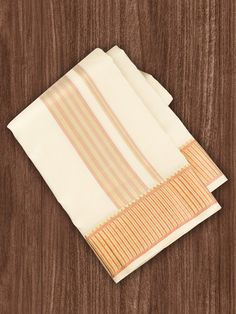 three folded napkins sitting on top of a wooden table