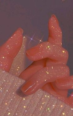 a woman's hand with glitter on it