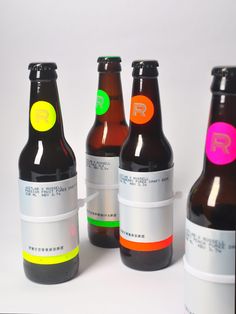 four bottles with different colored labels on them